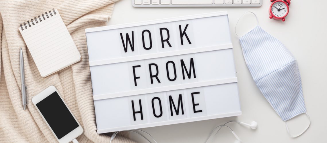 Work from home word on lightbox with working stuff and mask, quarantine for coronavirus or covid-19